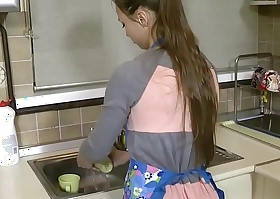 young wife encircling kitchen