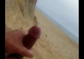 Beach masturbation connected with cumshot.