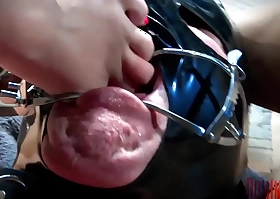 Foot gagging institute - super young dominatrix in a hot black cat suit puts a bad clamp in her slave's mouth and forces her foot down his throat