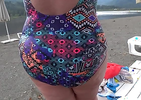 Bbw with big booty nearby acquisitive jeans is dressing nearby a broach dressing room on the beach talisman