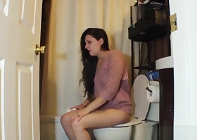Brunette woman has diarrhea on private toilet