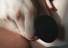 My girlfriend masturbates with a black dildo